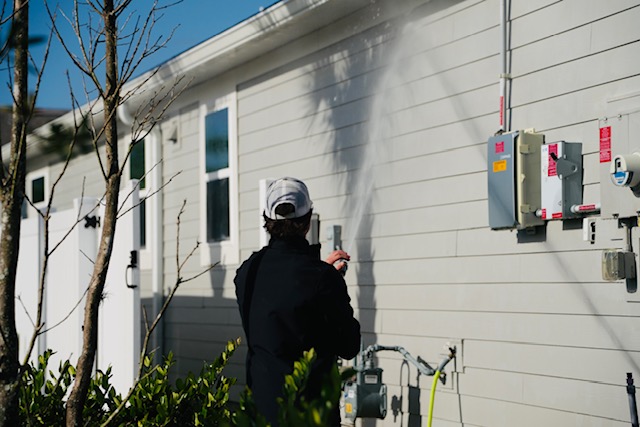 Longleaf Soft Wash cleaning the exterior siding of a residential home in St. Johns County